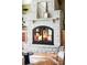 Close up shot of a grand stone fireplace in the living room with a glass door insert at 5101 Saint Vrain Rd, Longmont, CO 80503