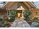 Charming home exterior with stone accents, a wooden door, and a well-manicured garden at 5101 Saint Vrain Rd, Longmont, CO 80503