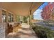 Inviting covered porch featuring stone columns, comfortable seating, and views of the property at 5101 Saint Vrain Rd, Longmont, CO 80503