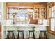 Open kitchen view with breakfast bar, wood cabinets, and scenic landscape views at 5101 Saint Vrain Rd, Longmont, CO 80503