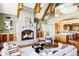 Open concept living room boasts a stunning stone fireplace, vaulted ceilings, and open to kitchen at 5101 Saint Vrain Rd, Longmont, CO 80503