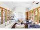 Spacious living room boasts hardwood floors, modern decor, and multiple doors leading to the exterior at 5101 Saint Vrain Rd, Longmont, CO 80503