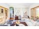 Open-concept living room with a wet bar, stone floors, wooden accents, and many windows offering natural light at 5101 Saint Vrain Rd, Longmont, CO 80503