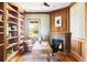 Home office with custom built-in bookshelves, fireplace, and wood paneling at 5101 Saint Vrain Rd, Longmont, CO 80503