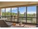 Enclosed balcony offers views framed by large windows, seating, potted plants, and glimpses of trees and blue skies at 14390 E Marina Dr # 403, Aurora, CO 80014