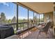 This enclosed balcony features floor-to-ceiling windows for panoramic views, and an outdoor dining set to savor the scenery at 14390 E Marina Dr # 403, Aurora, CO 80014