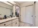 Bright bathroom featuring a granite counter top, neutral colors, and a door to the storage closet, providing functionality at 14390 E Marina Dr # 403, Aurora, CO 80014