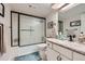 This bathroom features a shower with sleek sliding doors, vanity with a decorative countertop, and modern fixtures at 14390 E Marina Dr # 403, Aurora, CO 80014