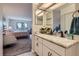 The bathroom's vanity showcases a granite countertop with sleek hardware, and an open view to the bedroom gives spacious feel at 14390 E Marina Dr # 403, Aurora, CO 80014