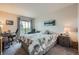This bedroom features workspace, balcony access with views, and natural light, ideal for work and rest at 14390 E Marina Dr # 403, Aurora, CO 80014