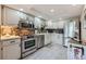 Updated kitchen with stainless steel appliances, modern backsplash, and ample cabinet space at 14390 E Marina Dr # 403, Aurora, CO 80014
