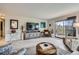 Cozy living room features wood-look floors, a balcony, and a decorative entertainment center at 14390 E Marina Dr # 403, Aurora, CO 80014