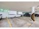 Wide angle shot of the parking garage, complete with white storage spaces, providing parking and storage convenience at 14390 E Marina Dr # 403, Aurora, CO 80014