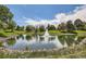 Scenic pond with a fountain surrounded by lush greenery, trees, and blue sky with fluffy clouds at 14390 E Marina Dr # 403, Aurora, CO 80014