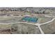 Aerial view of community tennis and pickleball courts surrounded by walking paths and open space at 1825 Spaulding Cir, Superior, CO 80027
