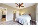 Bedroom featuring a ceiling fan, hardwood floors, ensuite bath, and access to a closet at 1825 Spaulding Cir, Superior, CO 80027