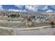 A scenic view of a community pool, clubhouse, and pond surrounded by lush landscaping at 1825 Spaulding Cir, Superior, CO 80027
