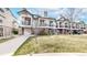 Charming townhouse with brick facade, front lawn, and private garage. Balconies offer outdoor space at 1825 Spaulding Cir, Superior, CO 80027