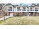 Townhouse with a well-maintained lawn and garden, brick accents, and private outdoor space with a balcony at 1825 Spaulding Cir, Superior, CO 80027