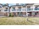 Brick facade townhome with balcony, manicured lawn and garden. Unit number 20 visible on the brick at 1825 Spaulding Cir, Superior, CO 80027