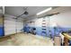 A clean garage space with a white door, equipped with storage racks and work area at 1825 Spaulding Cir, Superior, CO 80027