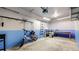 Spacious garage featuring an electric bike, storage solutions, workbench, and two-tone painted walls at 1825 Spaulding Cir, Superior, CO 80027