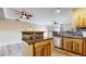 Open concept kitchen offers an island with countertop seating, mosaic backsplash, stainless steel appliances and natural wood cabinetry at 1825 Spaulding Cir, Superior, CO 80027