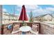 Outdoor patio with a table, chairs, pillows and an umbrella at 1825 Spaulding Cir, Superior, CO 80027