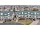 Aerial view of townhomes with green roofs, front lawns, garages, and balconies set in a community at 1825 Spaulding Cir, Superior, CO 80027