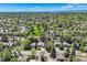 Desirable neighborhood aerial view features tree-lined streets and well-kept yards on a sunny day at 8820 W 80Th Dr, Arvada, CO 80005
