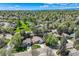 Charming neighborhood aerial view showcases lush green trees, well-maintained homes and blue skies at 8820 W 80Th Dr, Arvada, CO 80005