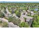 Eye-level aerial view of homes in a well-kept neighborhood surrounding a tranquil lake and green spaces at 8820 W 80Th Dr, Arvada, CO 80005