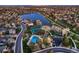 Stunning aerial view of a neighborhood with a pool, tennis courts, lake, walking path, and lush landscaping at 8820 W 80Th Dr, Arvada, CO 80005