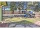 Fenced backyard with seating, mature trees, and rock features, providing a private outdoor retreat at 8820 W 80Th Dr, Arvada, CO 80005