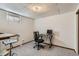 Finished basement area perfect as a home office, complete with a desk and chair at 8820 W 80Th Dr, Arvada, CO 80005