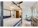 Comfortable bedroom offering a ceiling fan, four poster bed and ensuite bathroom at 8820 W 80Th Dr, Arvada, CO 80005
