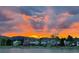 Community view showing homes in front of a brilliant sunset at 8820 W 80Th Dr, Arvada, CO 80005