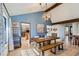 Inviting dining room featuring a wood table with bench seating and decorative lighting at 8820 W 80Th Dr, Arvada, CO 80005