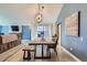 Open-concept dining room features a wood table, pendant lighting, and modern decor at 8820 W 80Th Dr, Arvada, CO 80005