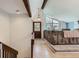 Welcoming entryway with exposed beams, wood floors, and steps down to a living area at 8820 W 80Th Dr, Arvada, CO 80005
