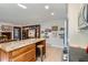 Open kitchen featuring a wooden island with granite countertops and views to the dining area at 8820 W 80Th Dr, Arvada, CO 80005