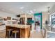 Stylish kitchen with center island, granite countertops, stainless steel appliances and hardwood floors at 8820 W 80Th Dr, Arvada, CO 80005