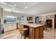 Spacious kitchen showcasing granite counters, island with seating, and stainless steel appliances at 8820 W 80Th Dr, Arvada, CO 80005