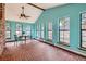 Bright sunroom filled with natural light, featuring brick floors and views of the outside at 8820 W 80Th Dr, Arvada, CO 80005