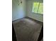 Simple bedroom with carpet, light walls, and a window for natural light at 16032 E Floyd Ave, Aurora, CO 80013