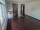 Open foyer with hardwood floors, modern railings, and natural light from a large window at 16032 E Floyd Ave, Aurora, CO 80013
