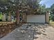 Home with a large tree in the front yard with an attached two-car garage and a concrete driveway at 16032 E Floyd Ave, Aurora, CO 80013