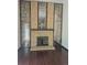 Living room with wood floors, a brick fireplace, and mirror accents at 16032 E Floyd Ave, Aurora, CO 80013