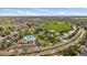 Aerial view showcases a large community park with a pool, tennis courts, baseball field and expansive green spaces at 292 S Pembrook St, Castle Rock, CO 80104