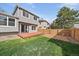 The backyard has a wooden deck, grassy area, wood fence, and is ideal for outdoor activities and relaxation at 292 S Pembrook St, Castle Rock, CO 80104
